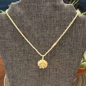 Elegant hand carved bone or ivory,?rose, hand, carved necklace